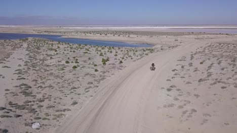 motorbike adventure on dirt road in baja california desert, aerial