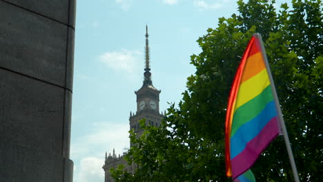 slow-motion lgbtq+ rainbow flag at warsaw palace of culture and science