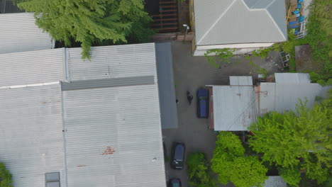 aerial shot overhead a motorbiker taking off from their house