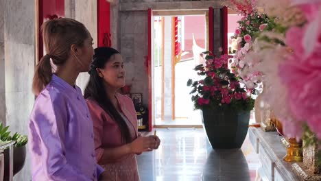 two women visiting a thai temple