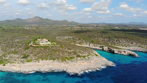 Drone-view-of-a-building-on-the-sore-of-the-island-Mallorca,-Spain