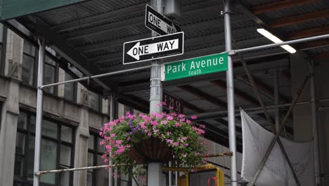 one-way crosswalk sign at park avenue south, nyc on a rainy day