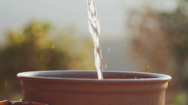 Water Pouring into a Terracotta Pot