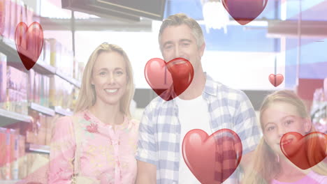 animación de corazones cayendo sobre la familia caucásica en el supermercado