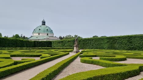 landscape of kvetna zahrada garden in kromeriz, czech republic with pavillion in the background, wide angle panning shot