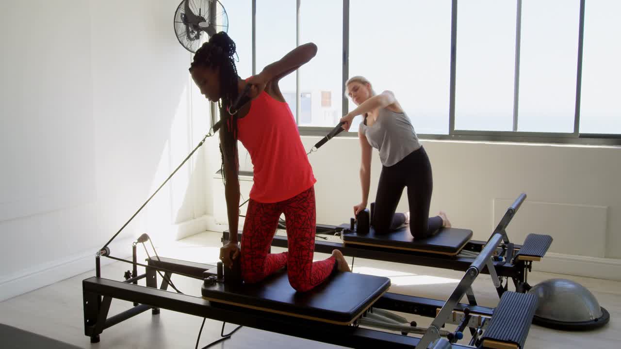 Women doing exercise on rowing machine 4k