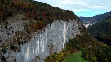 a mountain with a cliff and trees in the foreground