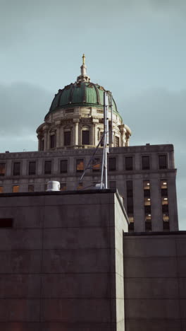 a view of a building with a dome against a cloudy sky