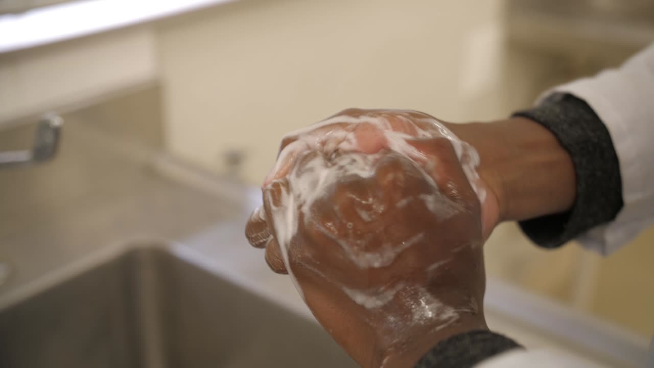 Proper hand washing technique, step 5: Backs of fingers to opposing palms with fingers interlocked