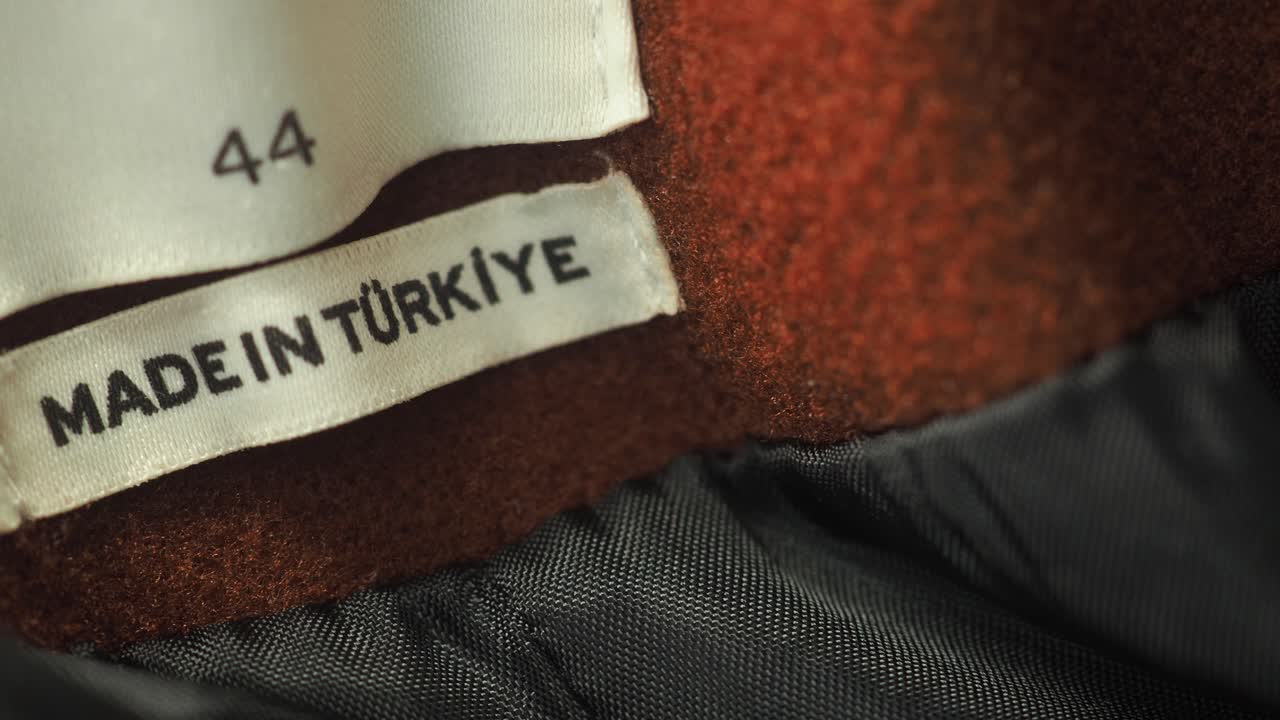 A close-up of a clothing label with the text 'Made in Turkey' and a size designation