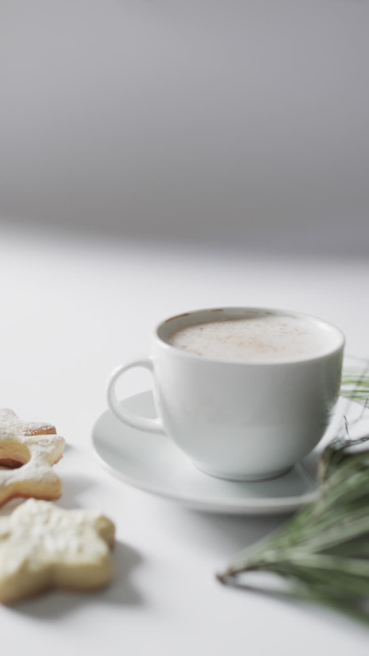 Vertical video of mug of christmas chocolate with cookies and copy space on white background