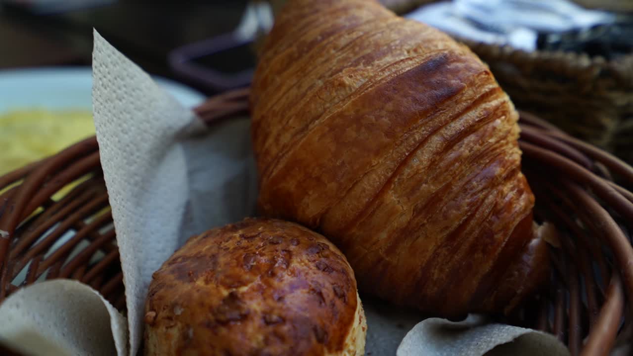 Breakfast pastry basket including a cheese scone and a classic croissant