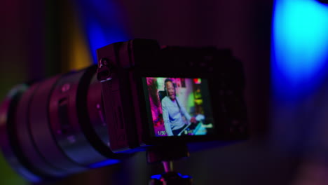 a photographer sets up their camera on a tripod