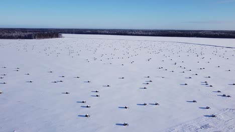 Hay-roll-filed-covered-with-snow-aerial-view-low-sunlight-long-shadows