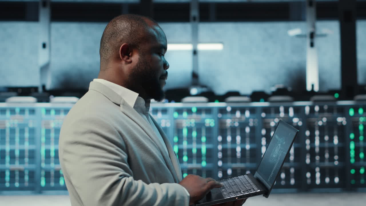 Vertical video Manager overseeing server room, walking with laptop, troubleshooting hardware