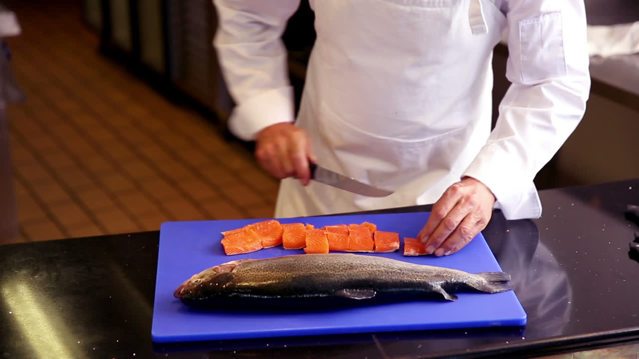Chef preparing fillet of salmon