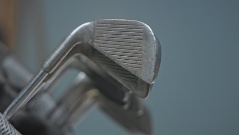 close-up shot of a used golf iron club being removed from a golf bag