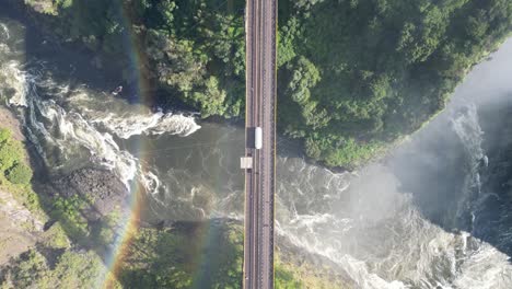 Aerial-Drone-View-Of-Victoria-Falls-And-Its-Rainbows,-In-Between-Zambia-And-Zimbabwe