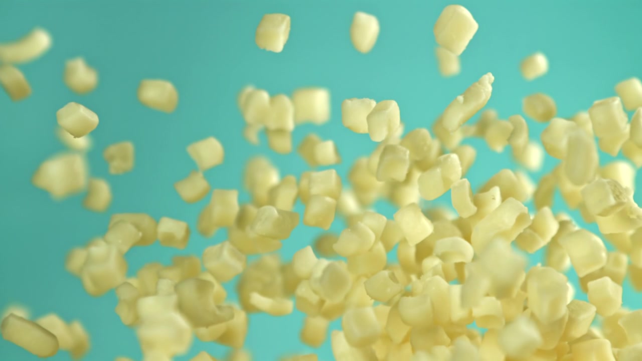 Sugar Cubes Falling in Slow Motion Against a Teal Background