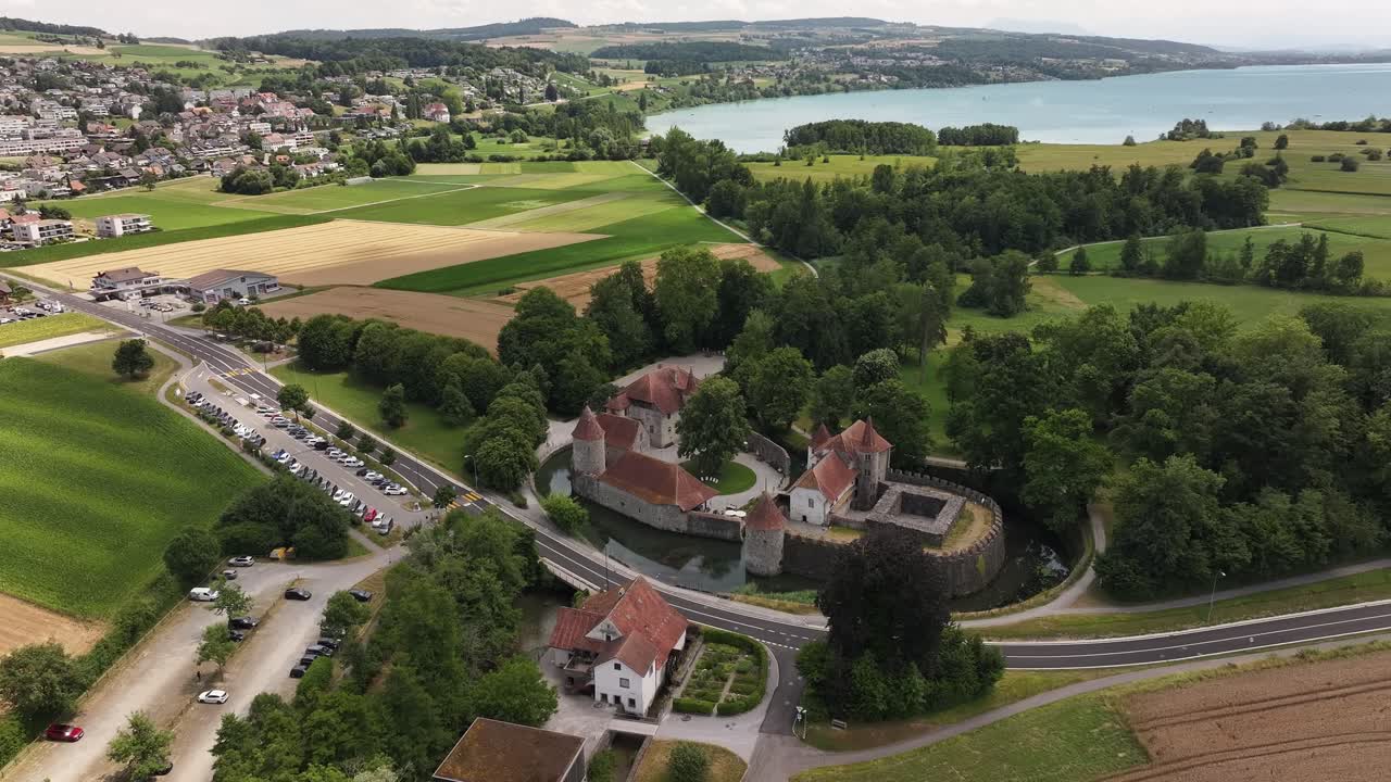 Aerial view of Hallwyl Castle surrounded by fields and near Hallwilersee in Seengen, Switzerland