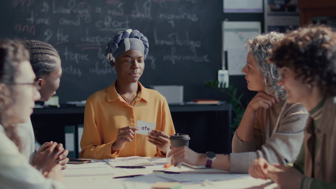 African American Female Student Discussing Flashcard with Teacher and Classmates