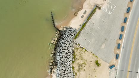 tracking along large boulders placed to prevent sand-loss