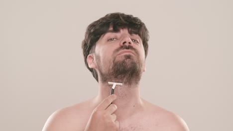 man shaving his beard