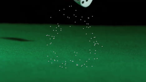 falling dice over green surface with particle animation forming circle