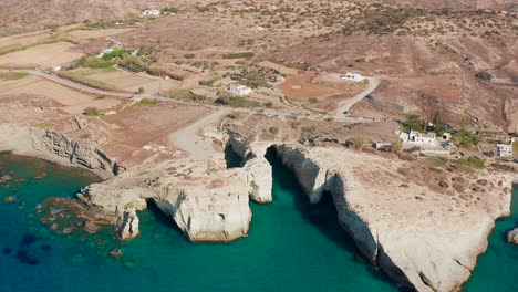 papafragas caves aerial view in milos island, secluded beach cove in greece