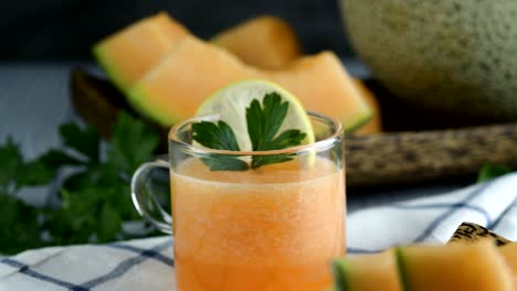 whole and sliced of japanese melons,honey melon or cantaloupe (cucumis melo) glass of melon smoothie healthcare concept.