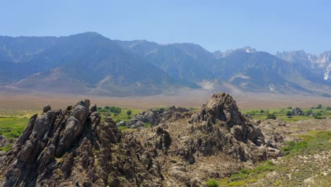 4K-aerial-of-rocks-by-Alabama-Hills-with-Mount-Whitney-in-the-background,-in-California,-USA