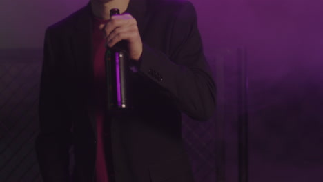 young man drinking beer and dancing at disco