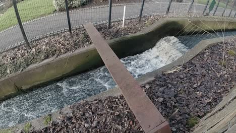 Slow-motion-river-reservoir-overflow-channel-water-overflowing-dam-narrow-feed