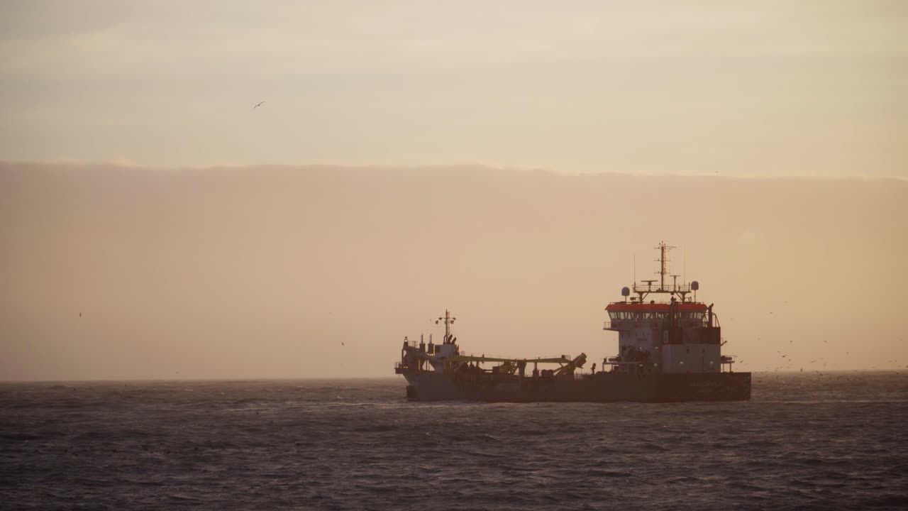 Dredger Ship at Sea During Sunset