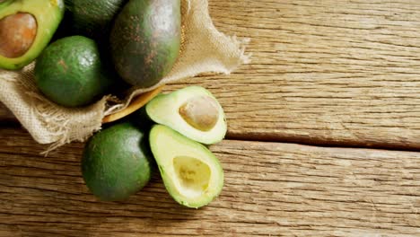 avocados in jute fabric placed on wooden table 4k 4k