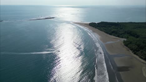 boat sailing into the shore of costa rica during the dat