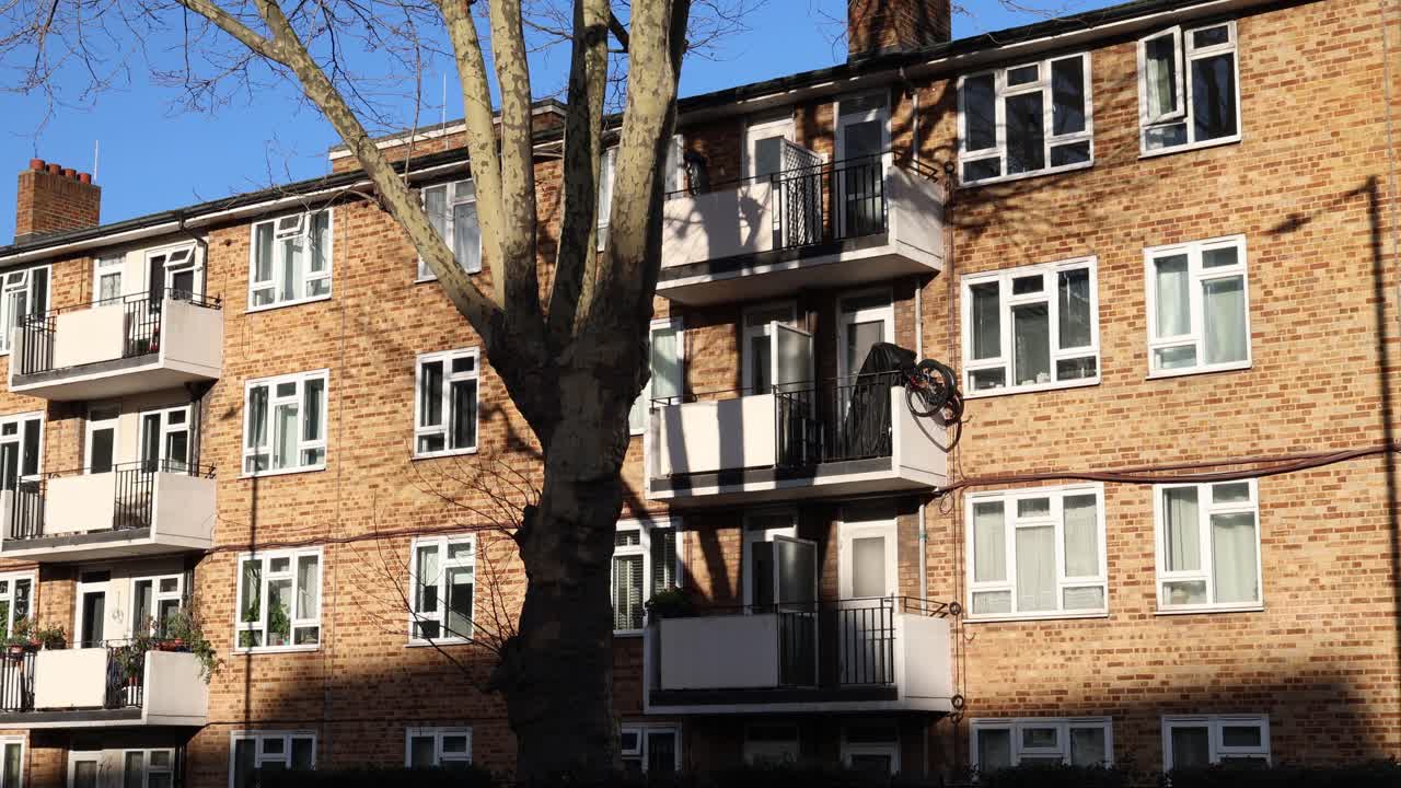 Traditional British apartment building with brick facade, residential neighborhood establisher