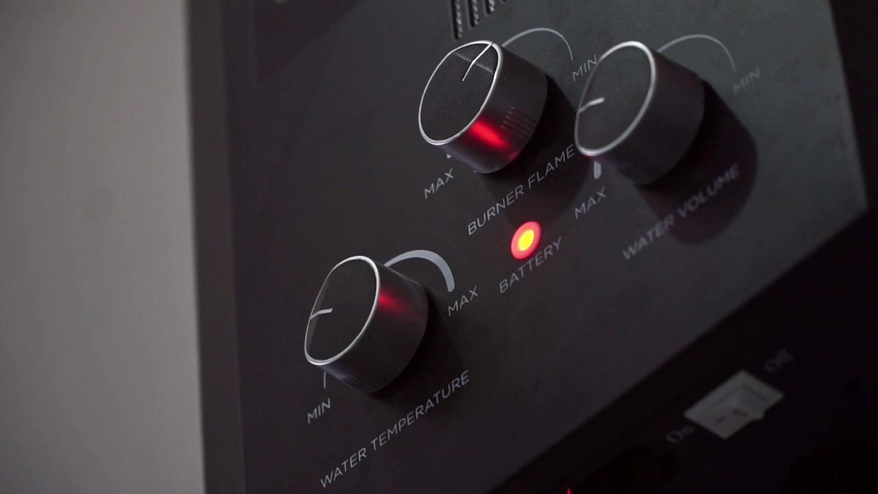 Gas water heater control panel with red indicator light on, close up shot, home appliance technology, bathroom equipment footage.