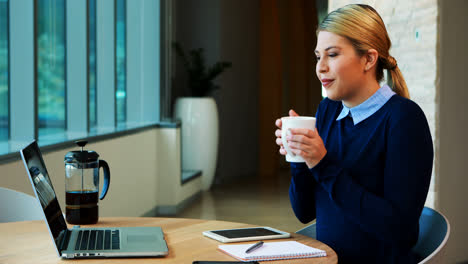 female executive having a video call on laptop