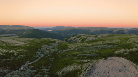 gradient sunset sky beyond the mountains of rondane national park in norway -aerial