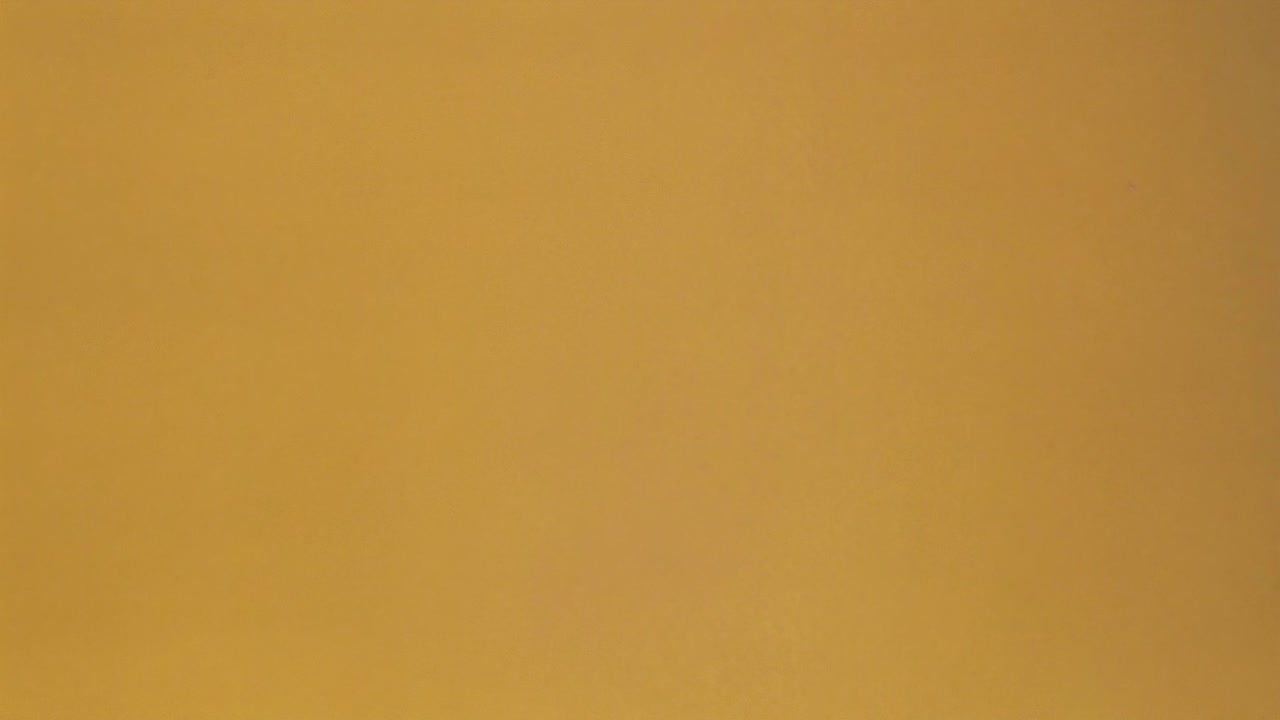 Low-angle shot of a robotic arm placing a cardboard box, showcasing automation in logistics