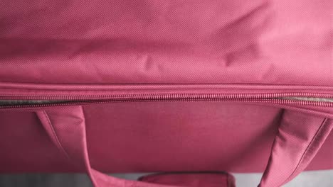 pink suitcase with child's dress inside