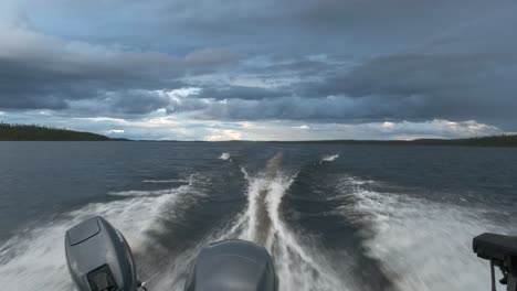 fishing boat speeding on lake on a cloudy afternoon