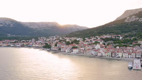 aerial boom shot of a quiet village on krk island croatia early in the morning