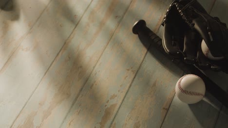 overhead studio baseball still life with bat ball and catchers mitt on aged wooden floor 1