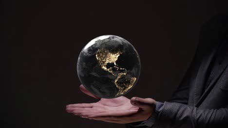 planet earth world globe illuminated at night rotate above palm hand , creation gods religion robot artificial intelligence concept