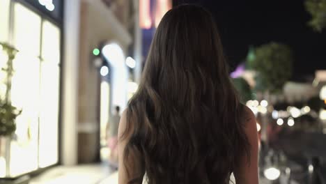 woman walking at night in a city