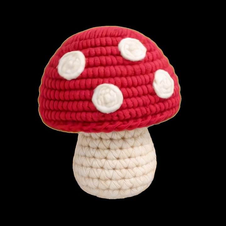 Handmade Crocheted Mushroom Toy on Black Background