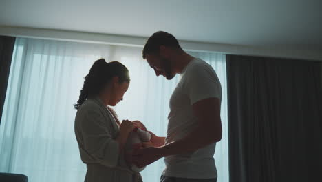 parents lovingly holding newborn baby