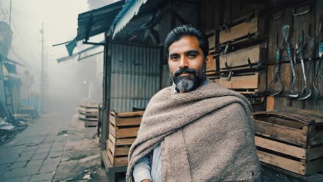 confident mature merchant with a grey beard and mustache, wearing warm clothes, standing proudly in a foggy marketplace stall, surrounded by the vibrant atmosphere of asian culture